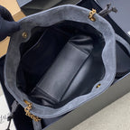 Blue-gray suede YSL bag open to reveal black leather interior and pocket