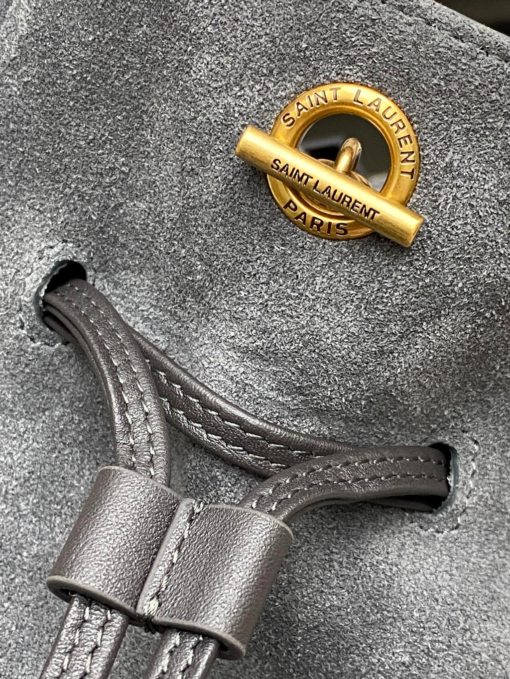 Leather strap with SAINT LAUREN T PARIS stamp on gray suede bag