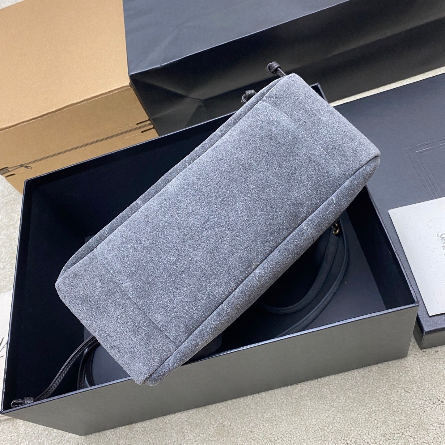 Blue-gray suede YSL bag with structured side and long top carry strap