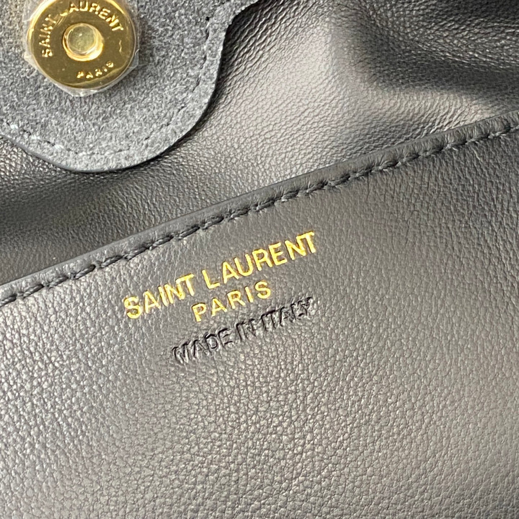 Gold SAINT LAURENT PARIS branding on gray leather bag panel