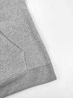 Gray hoodie hem with ribbed trim and side seam detail.