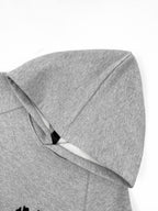 Gray hoodie close-up of hood and seam detail.