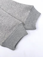 Gray hoodie sleeve and ribbed cuff close-up.