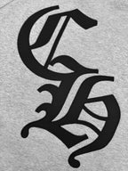 Gray hoodie fabric close-up with large black logo graphic.