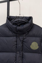 Moncler dark puffer jacket chest area with round buttons and logo patch