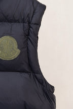 Moncler dark padded vest side seam detail with logo patch