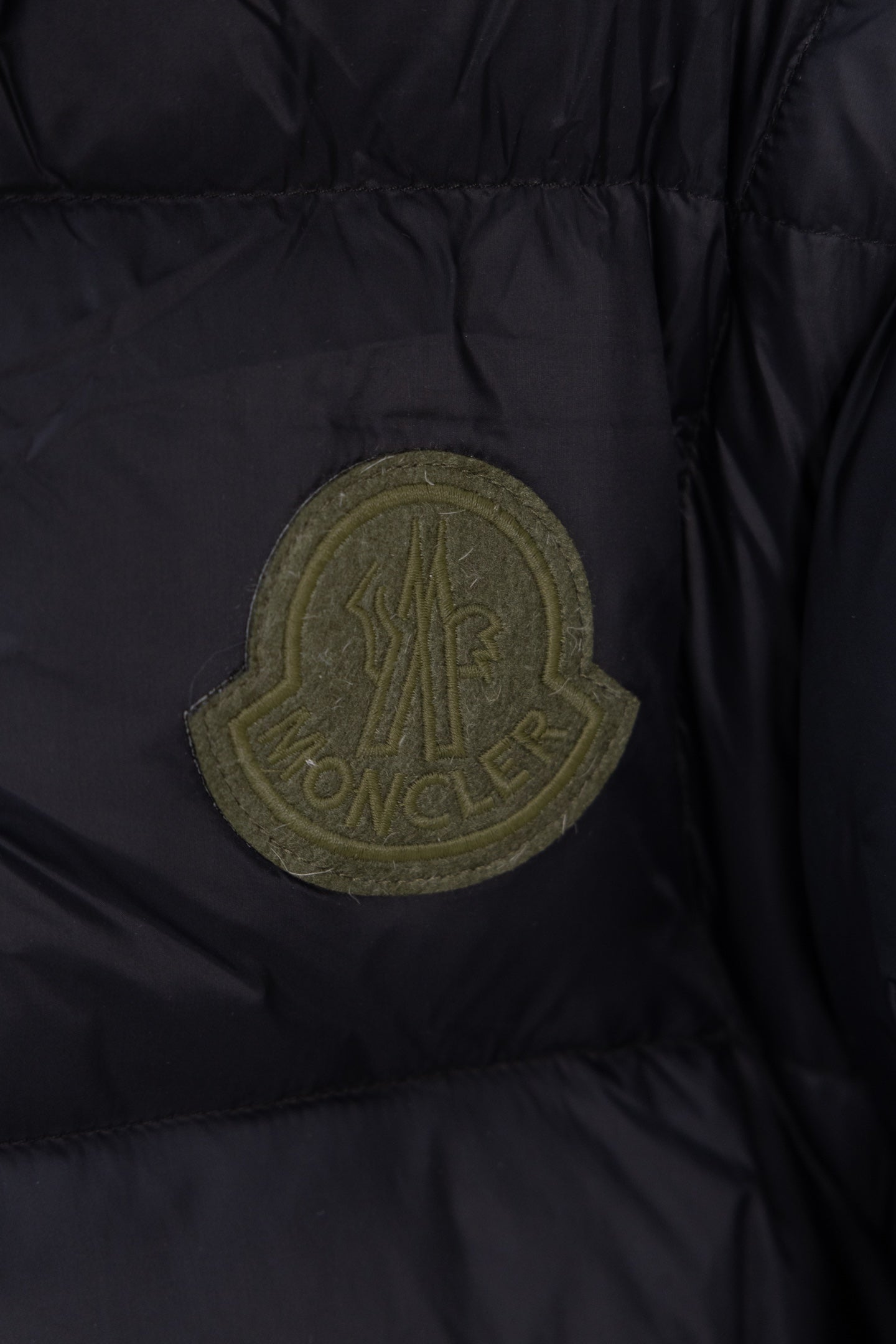 Moncler logo patch on dark navy puffer jacket