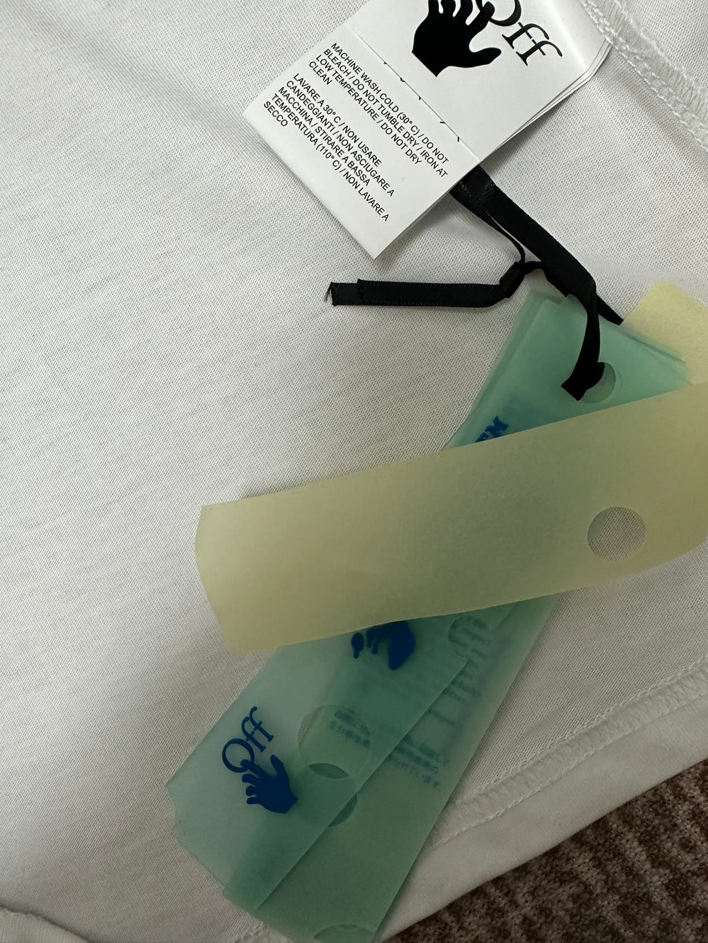 Off White T-shirt with hang tag and folded fabric on top