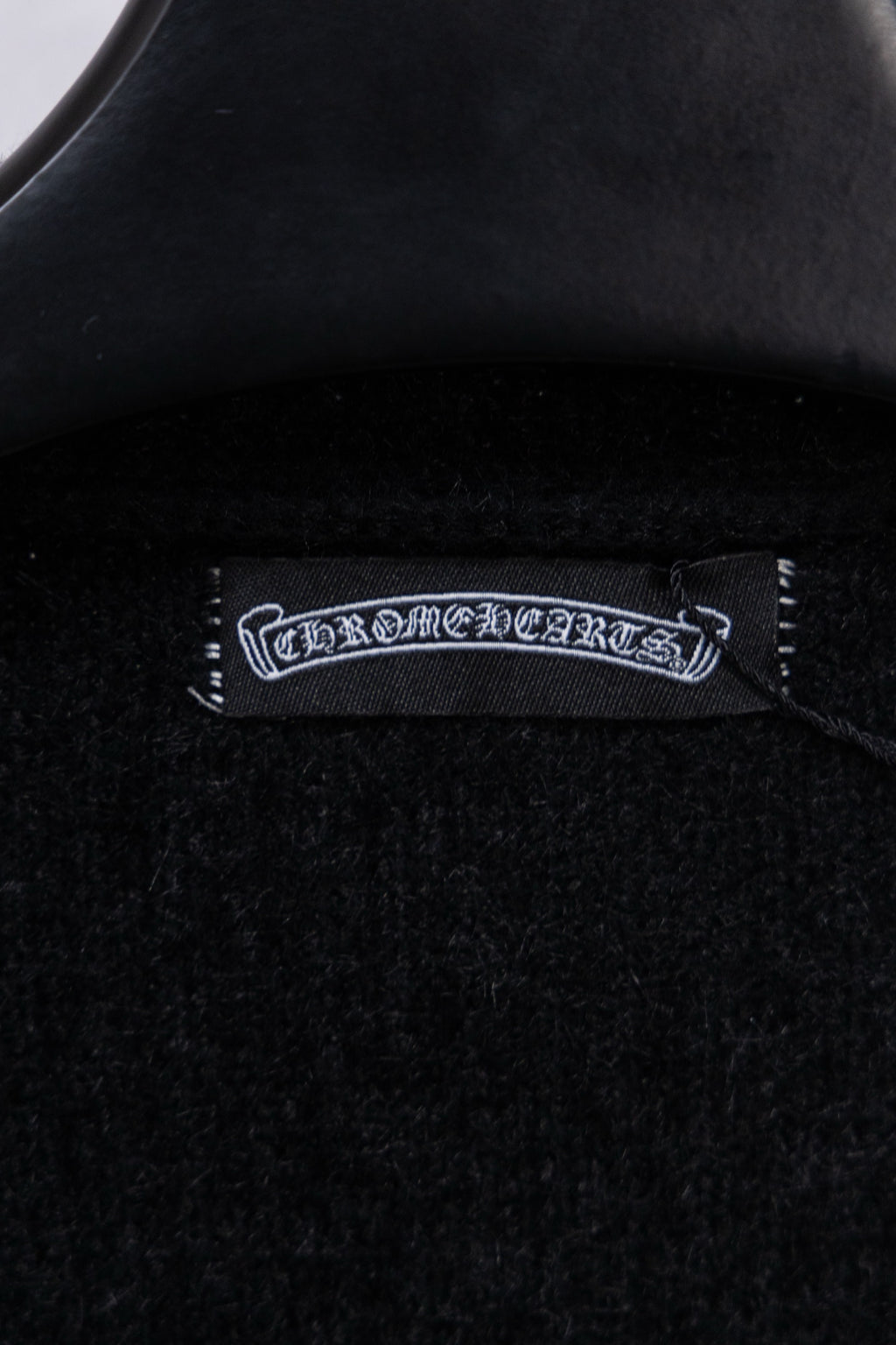 Black cardigan interior neck label with embroidered brand text