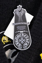 Black cardigan with white hang tag featuring crest-style graphic