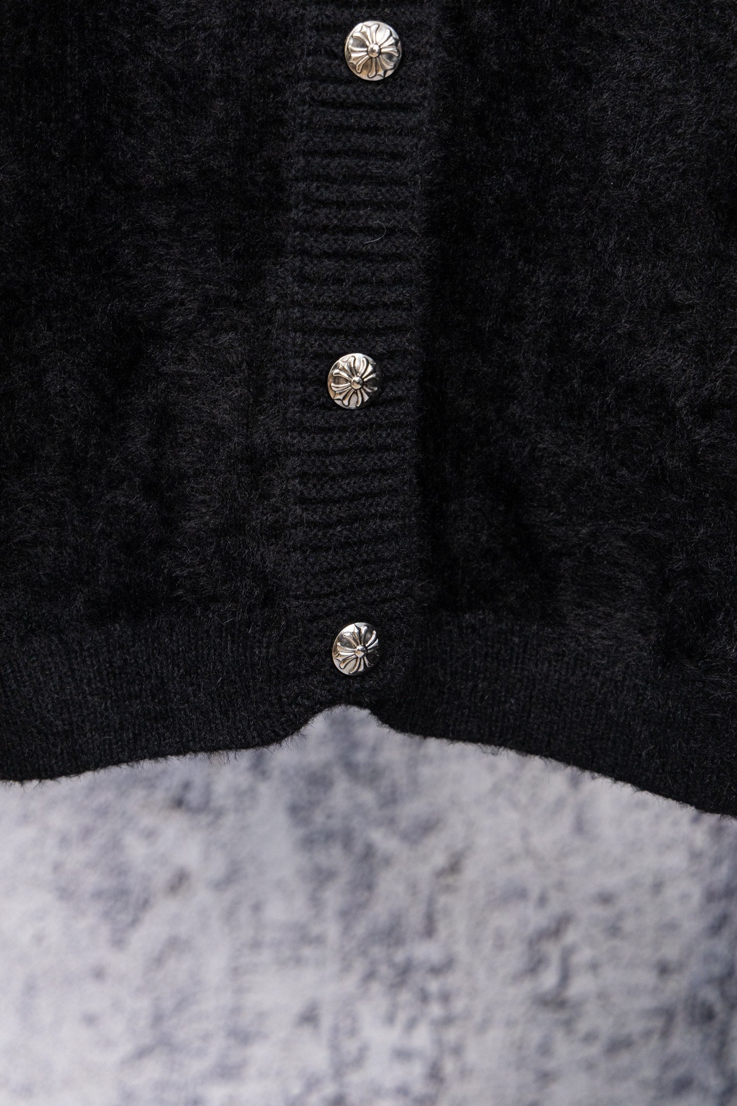 Black cardigan center front with three decorative metal button accents
