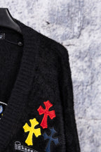 Black cardigan sleeve with red and yellow cross-style embroidered patches