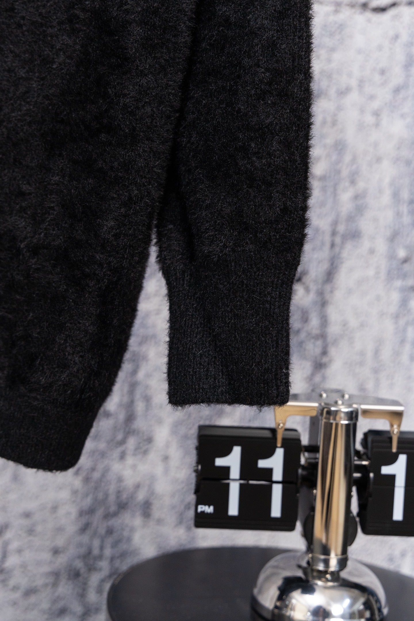 Black long-sleeve top, visible lower torso and sleeve cuff seam