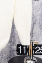 White cardigan sweater hem close-up
