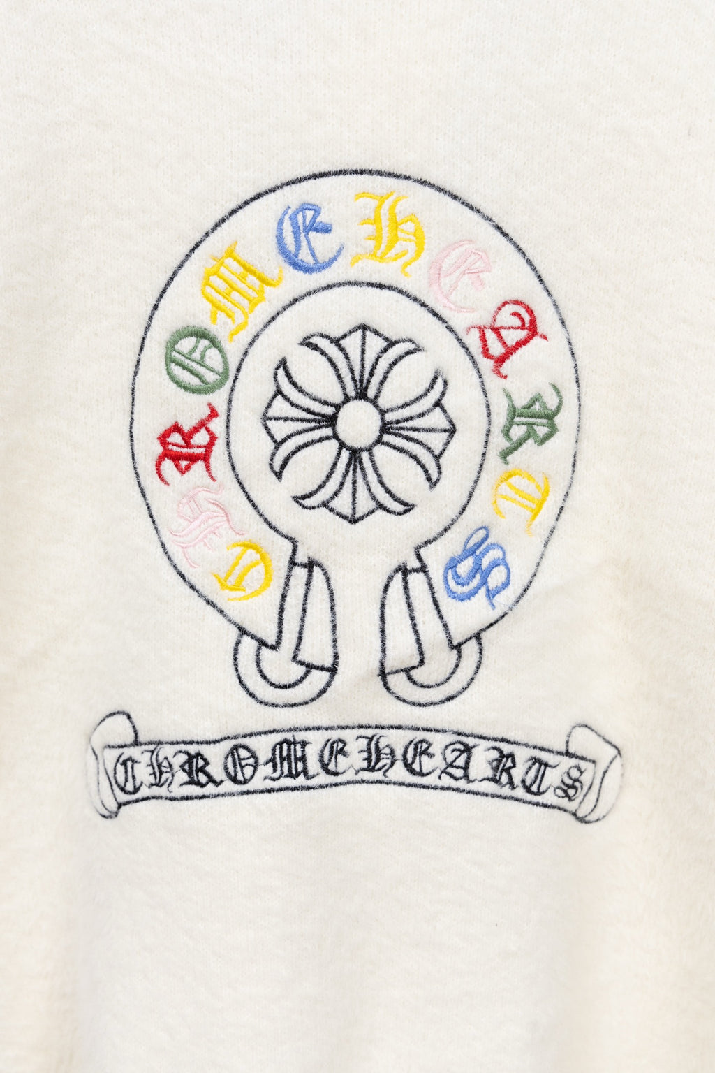 White long-sleeve T-shirt with round crest graphic and Chrome Hearts banner