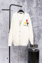 White cardigan sweater with button front and colorful chest patch