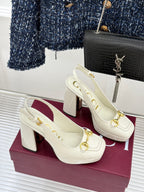 Cream leather heeled loafers with gold chain buckle detail and thick heel