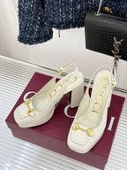 Pair of cream leather heeled mules with gold bit hardware and block heel