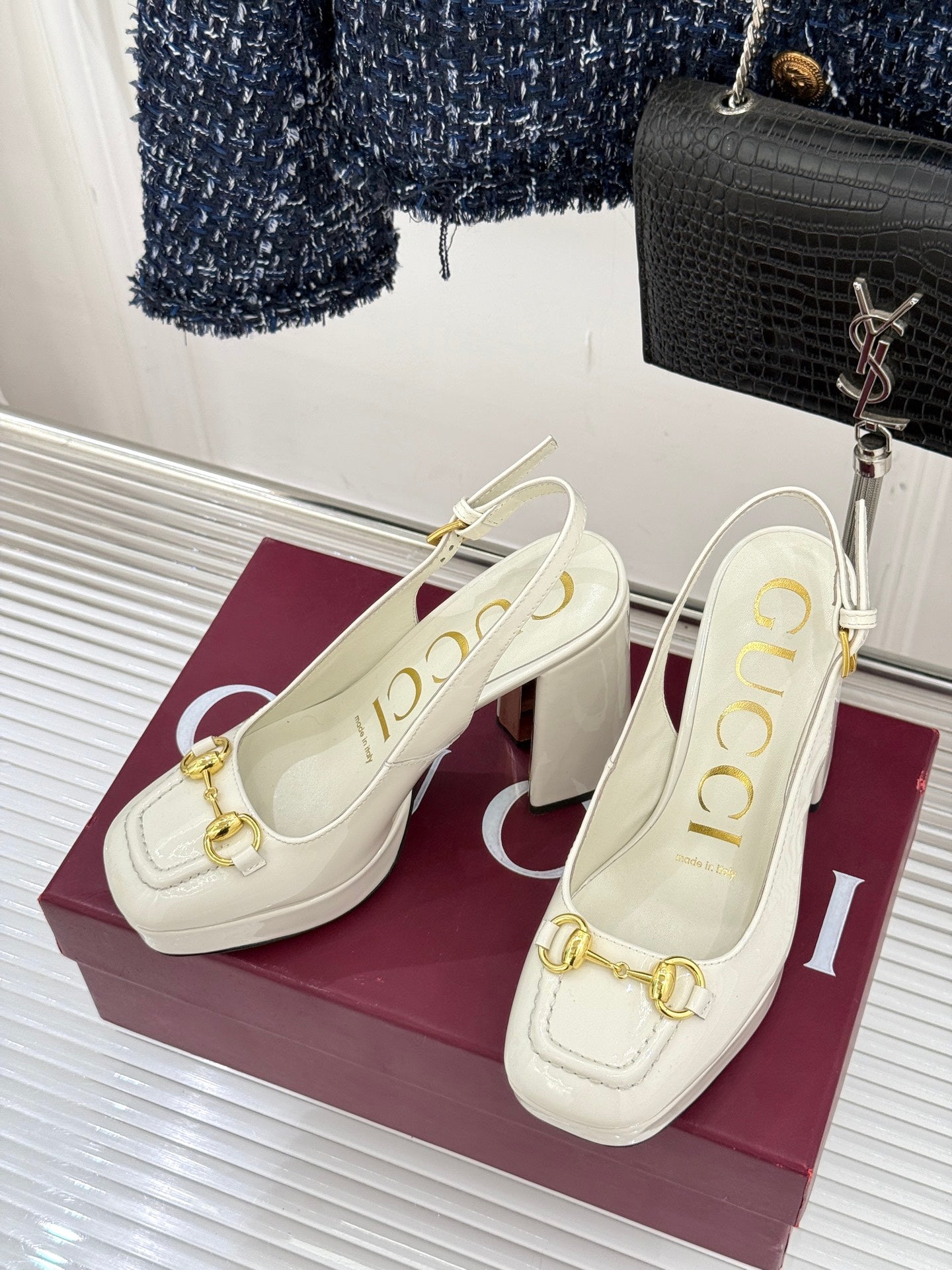 Pair of cream leather heeled mules with gold bit hardware and block heel