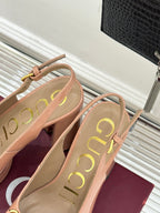 Light pink slingback pumps with gold horsebit buckle, rounded toe