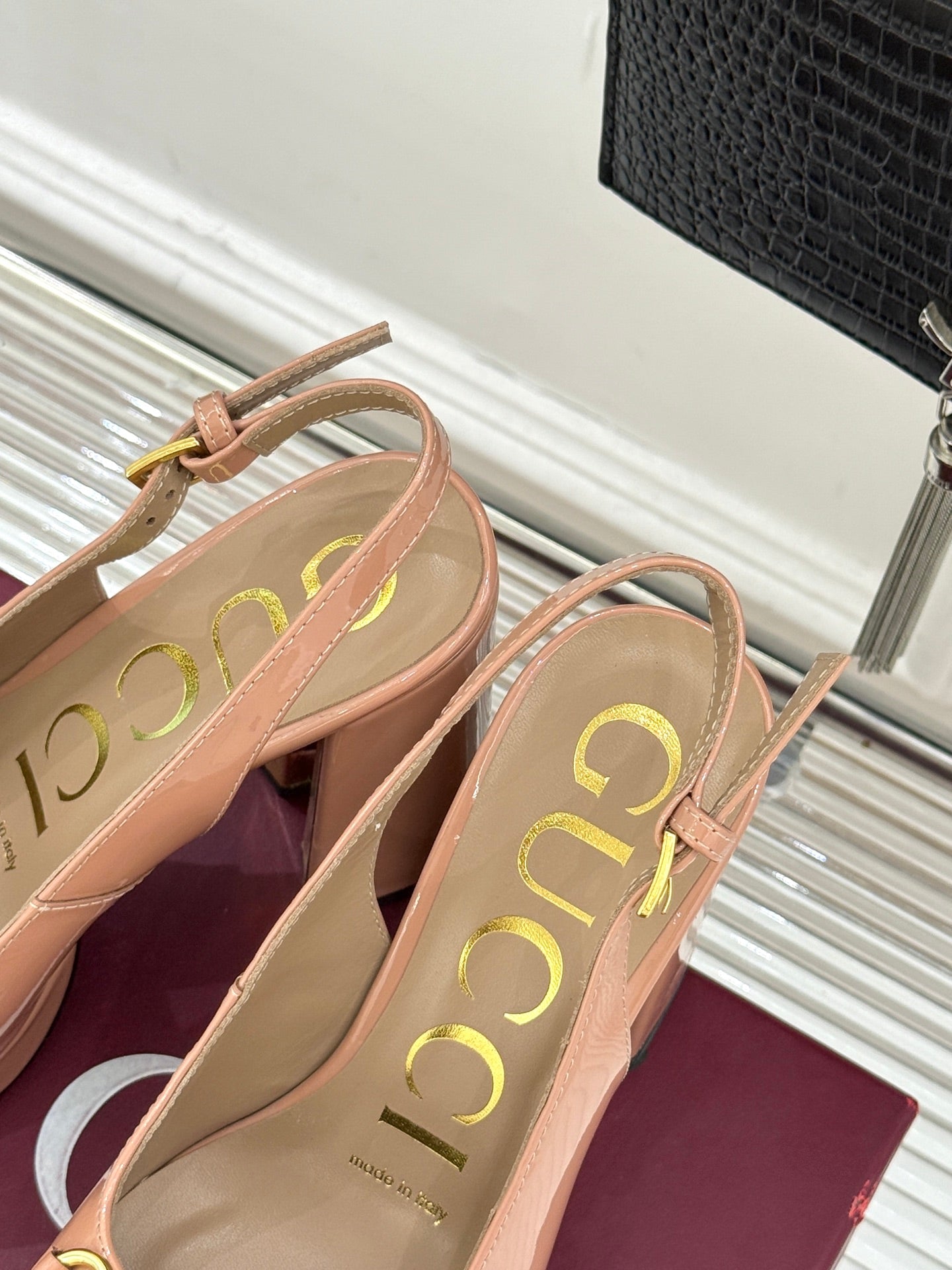 Light pink slingback pumps with gold horsebit buckle, rounded toe