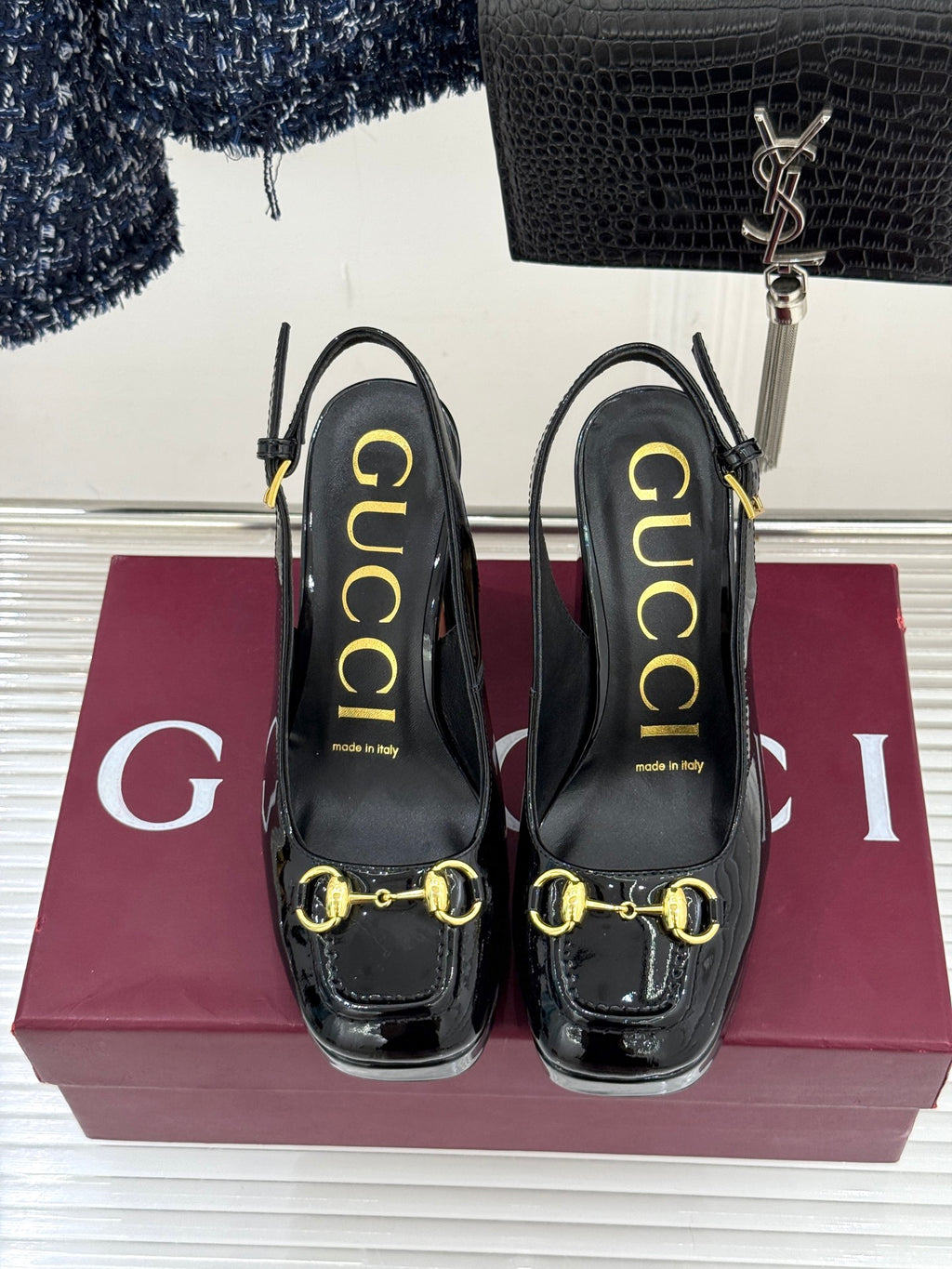 Gucci black patent heeled shoes with gold horsebit detail and molded heel support
