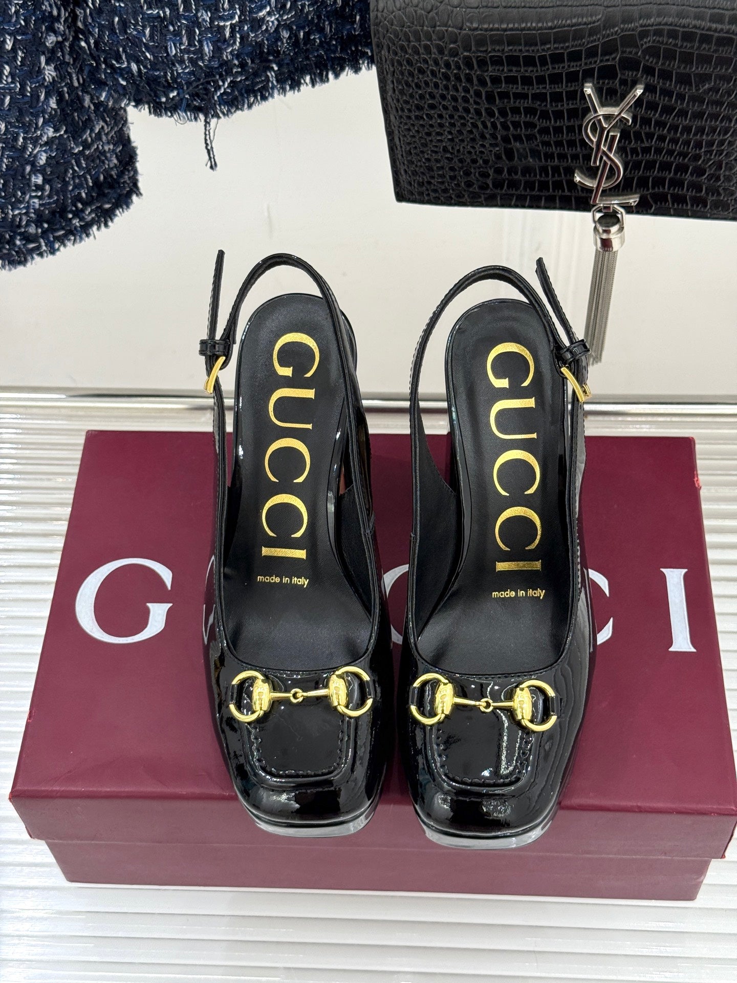 Gucci black patent heeled shoes with gold horsebit detail and molded heel support