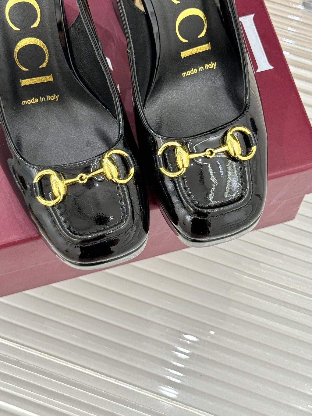 Gucci black patent platform heeled shoes with gold chain-link horsebit trim