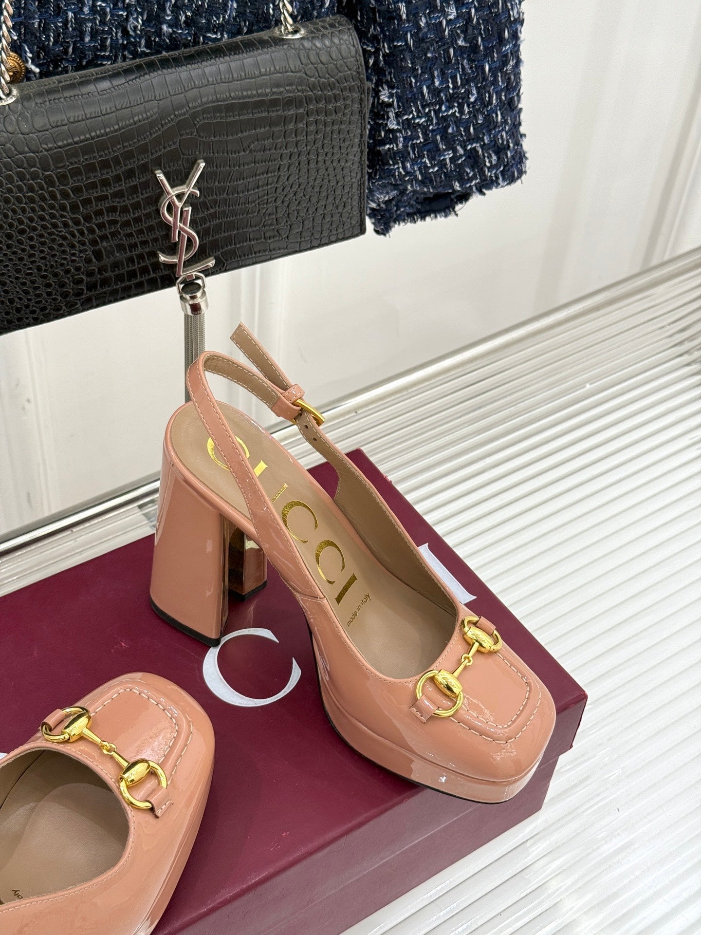 Light pink heeled slingback pumps with gold buckle and open back