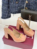 Light pink slingback pumps with chunky heel and gold horsebit buckle on front