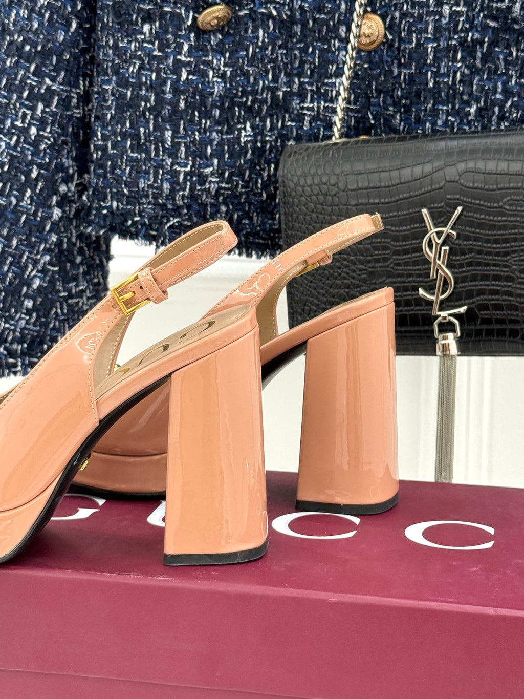 Light pink slingback pumps with square heel and gold horsebit buckle
