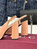 Light pink slingback pumps with square heel and gold horsebit buckle