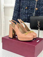 Light pink heeled slingback pumps with gold horsebit buckle strap