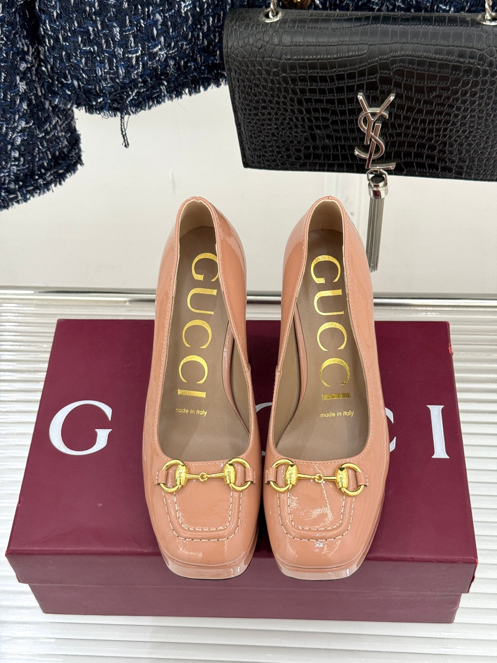 Gucci peach patent leather pumps showing gold horsebit trim and tall block heel