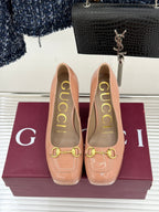 Gucci peach patent leather pumps showing gold horsebit trim and tall block heel