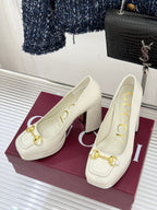 Gucci white leather loafer heels with gold horsebit detail, pair on magenta box