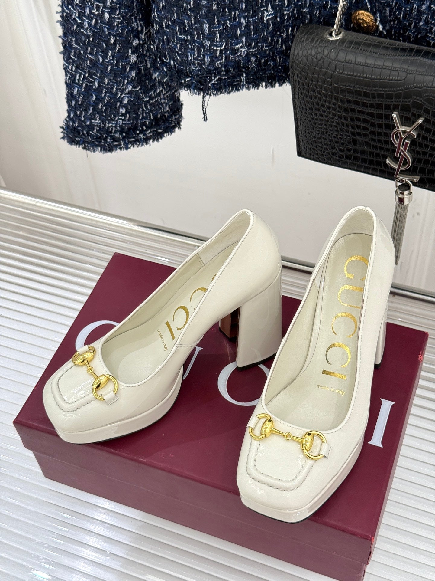 Gucci white leather loafer heels with gold horsebit detail, pair on magenta box