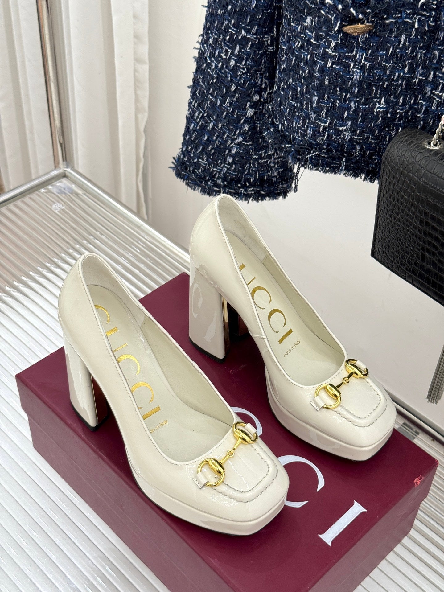 Gucci white leather loafer heels with gold horsebit, pair side by side