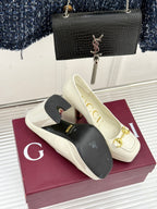 Gucci white leather loafer heels with gold horsebit detail, shown on box