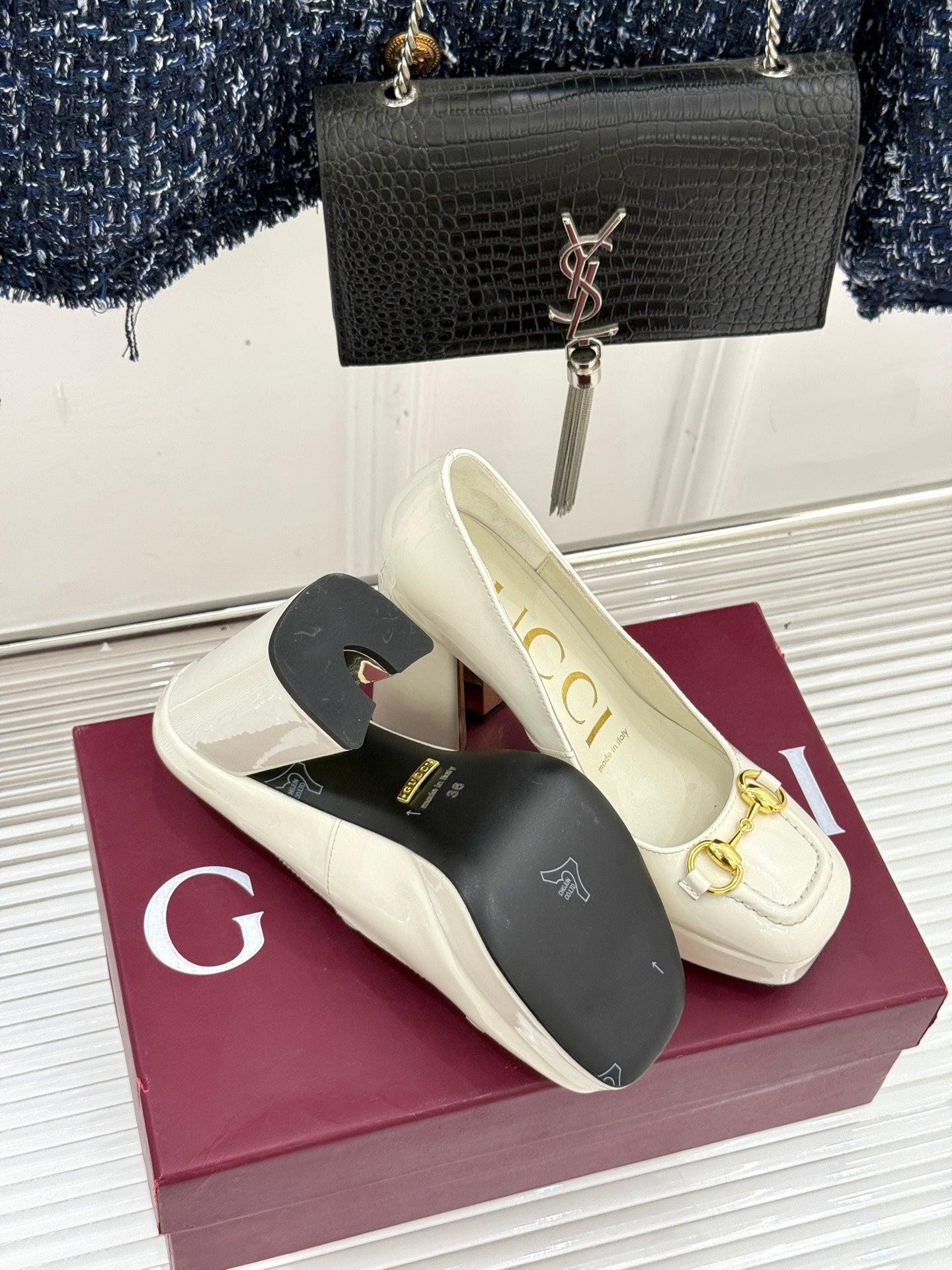 Gucci white leather loafer heels with gold horsebit detail, shown on box