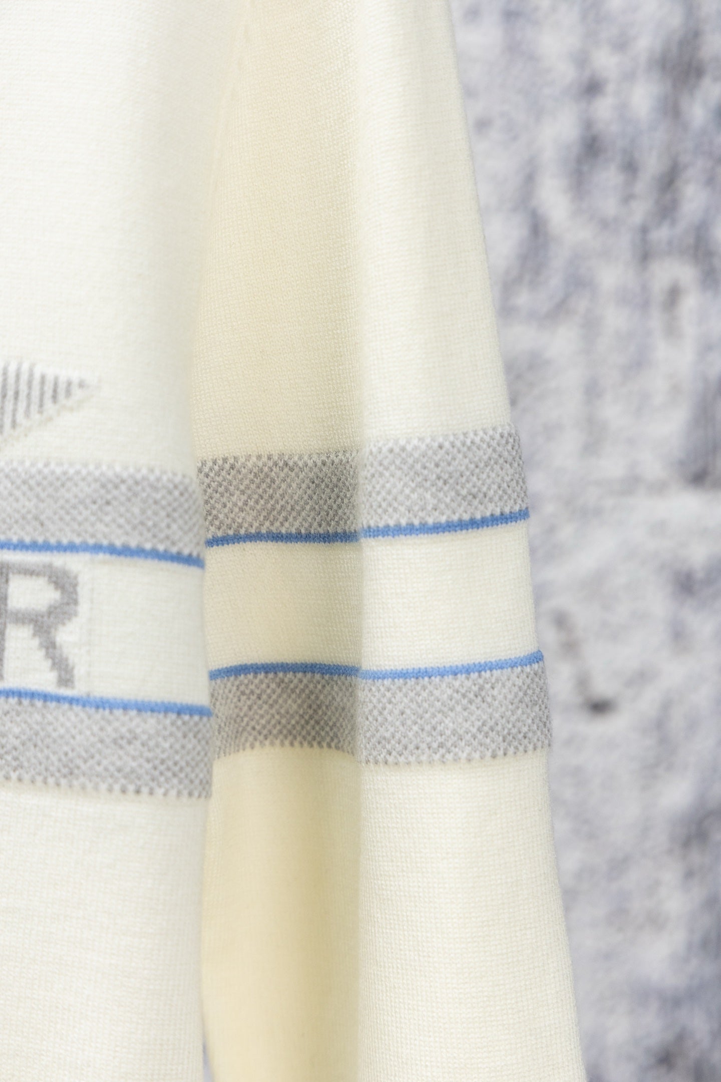 Cream long clothing fabric with blue horizontal stripes and stitched hem