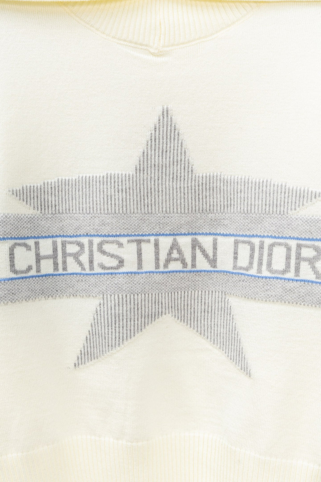 Cream sweater with gray star graphic and blue stripe band reading CHRISTIAN DIOR