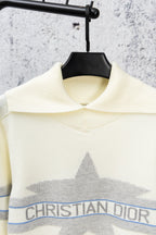 Cream turtleneck sweater with star graphic, blue stripe band, and Christian Dior logo