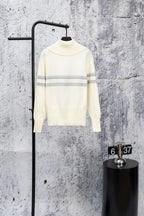 Cream long-sleeve sweater with high neck and blue stripe bands, minimal logo detail