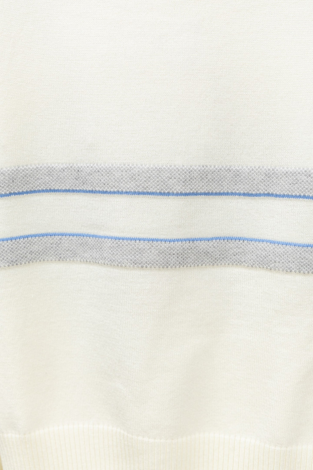 Cream sweater fabric with horizontal blue stripe band and fine knit texture