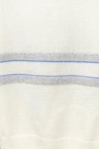 Cream sweater fabric with horizontal blue stripe band and fine knit texture