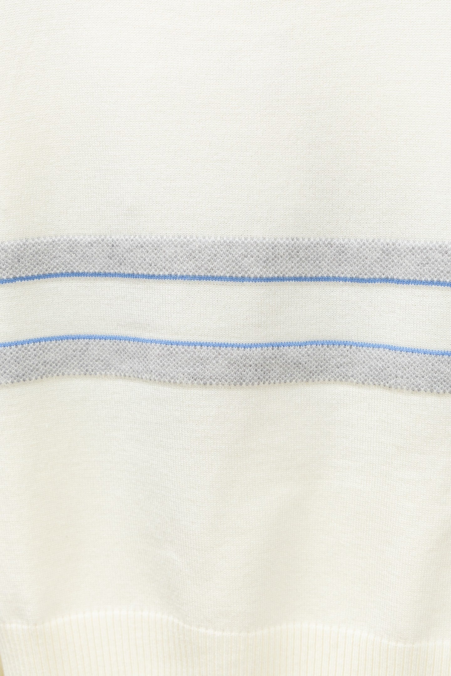 Cream sweater fabric with horizontal blue stripe band and fine knit texture