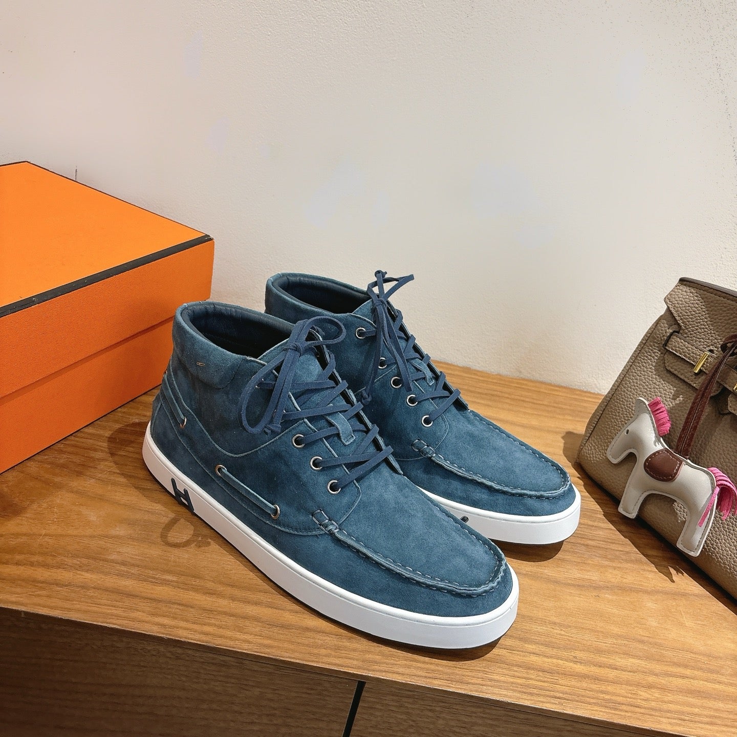 Unisex blue suede lace-up shoes, low-top with white soles and contrast stitching