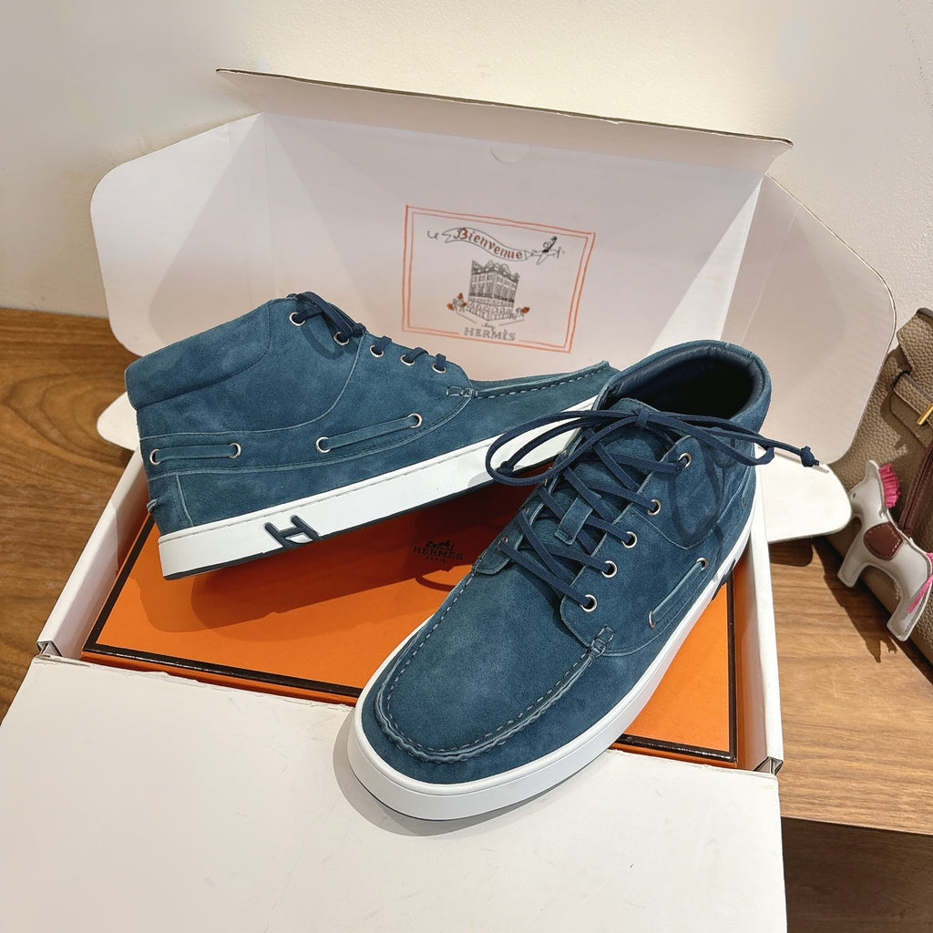 Unisex blue suede lace-up shoes with white rubber soles and metal eyelet detailing