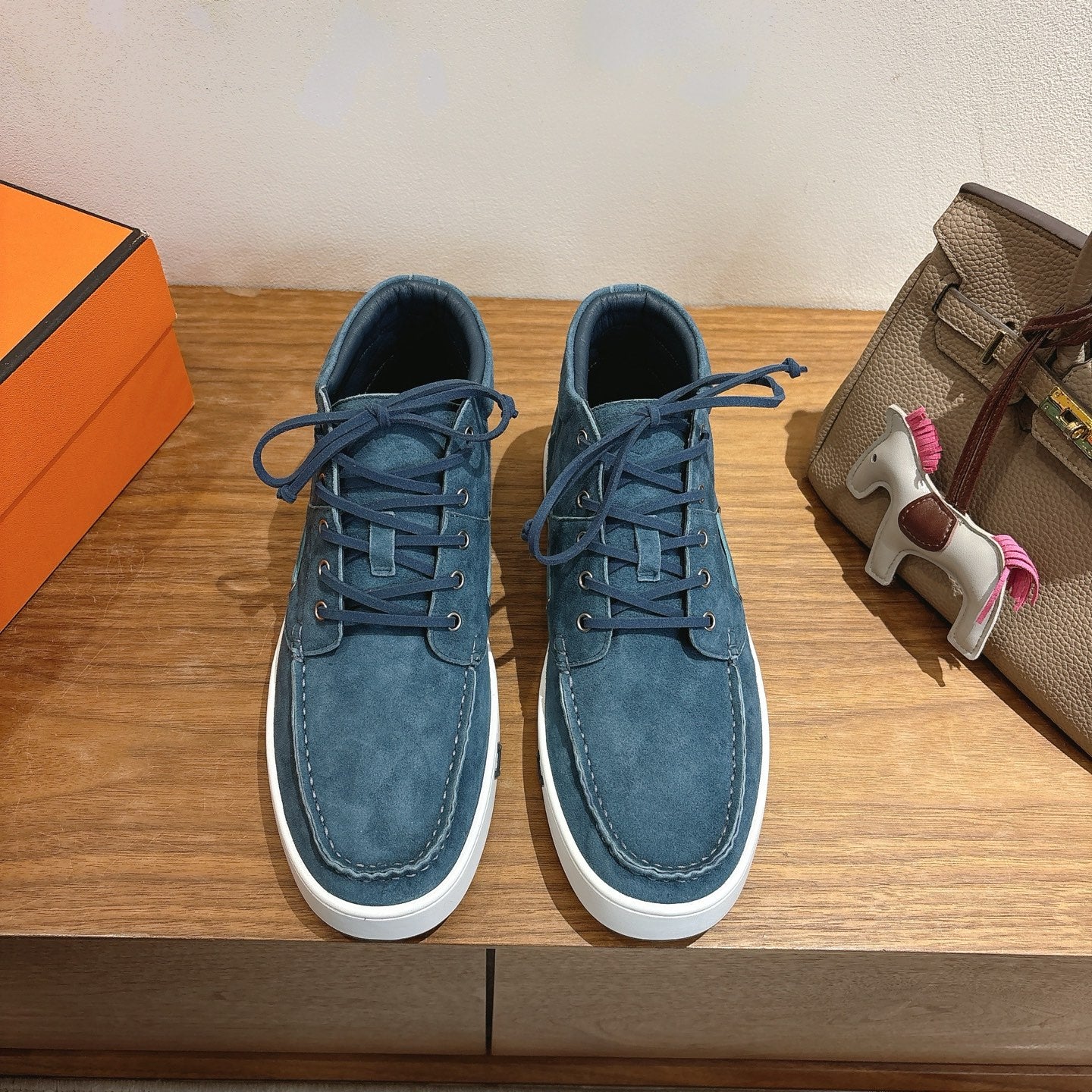 Unisex blue suede lace-up shoes with white rubber soles and eyelet laces